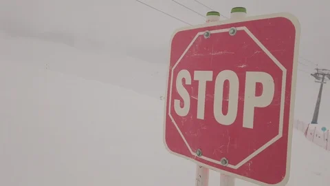 Stop sign on top of mountain at winter snowy ski resort Stock Footage 103853556