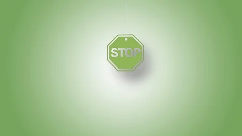 Stop Sign in Yellow Hanged with String On Green Background in 4K Resolution Stock Footage 125931217