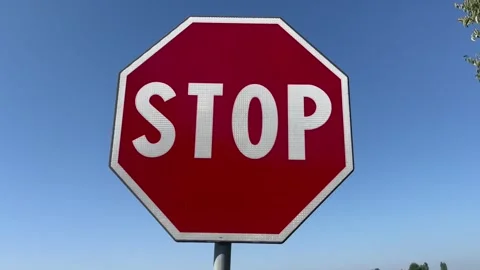 Stop signal, full sun with blue sky in background Stock Footage 248044797