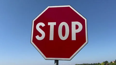 Stop signal full sun with blue sky in background Stock Footage 248044800
