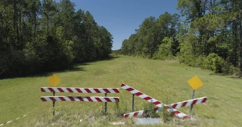 Stop signs at dead end road, flying up through canopy of trees drone aerial 4K Stock Footage 111365484