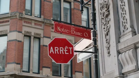 Stop singn and Rue Notre-Dame Ouest sign in Montreal, Canada Stock Footage 128968737