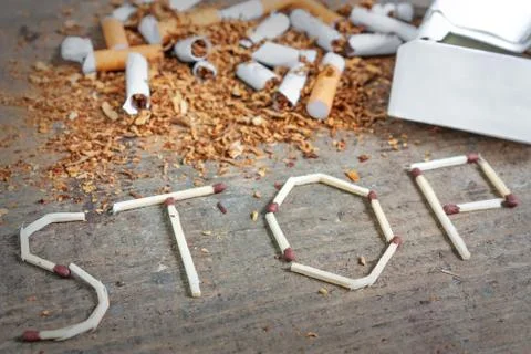 Stop smoking background with broken cigarettes and tobacco Stock Photos