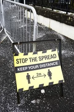 Stop the spread keep your distance sign during the pandemic Stock Photos