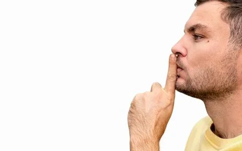 Stop talking gesture. Shushing or shh. Man holds his index finger on his lips Stock Photos
