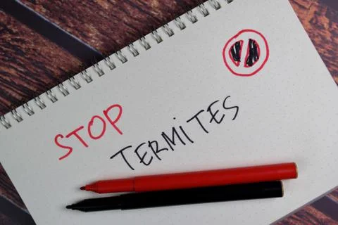 Stop Termites write on a book isolated wooden table. Stock Photos