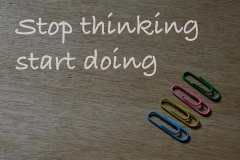 Stop thinking start doing.Motivational quote over wooden background. Foto stock