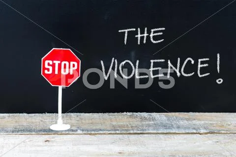 STOP THE VIOLENCE message written on chalkboard Stock Photos