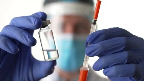 Stop virus forever. Focus is moving from concentrated male doctor wearing Stock Footage 147961391