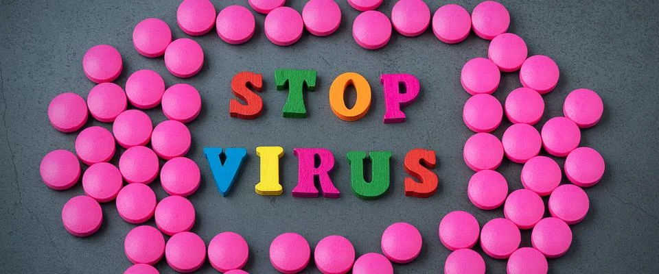 Stop the virus in a frame of scattered tablets. Stock Photos