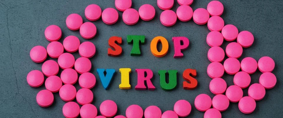 Stop the virus in a frame of scattered tablets. Stock Photos