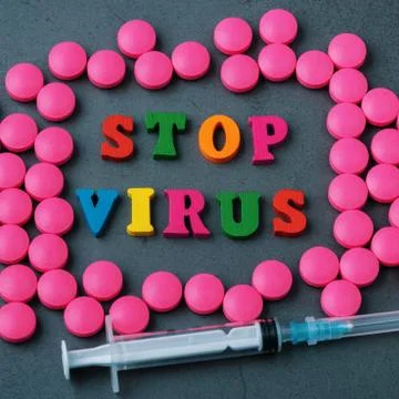 Stop the virus in a frame of scattered tablets. Stock Photos