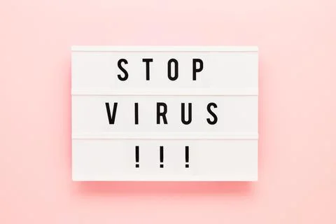 STOP VIRUS written in light box on pink background. Healthcare and medical Stock Photos