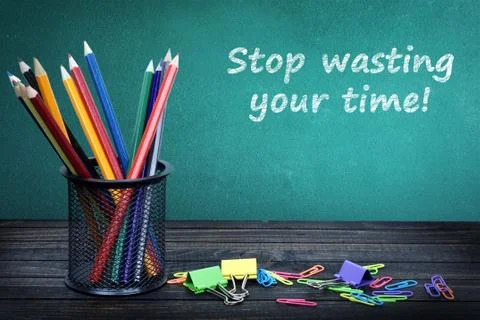 Stop wasting your time text on green board Stock Photos