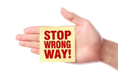 Stop Wrong Way Hand with Stop Wrong Way note is isolated on white backgrou... Stock Photos