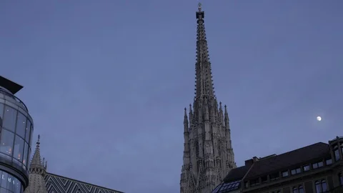 Stopmotion of moon emerging among clouds behind the Stephansdome cathedral tower Stock Footage 117164157