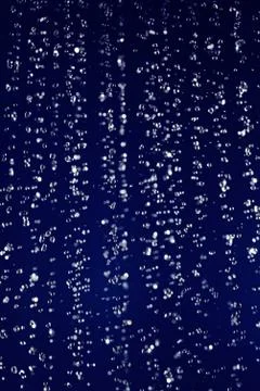 Stopped motion water drops background on deep blue Foto stock