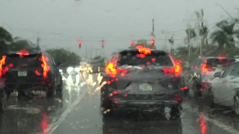 Stopped at Traffic Light at Clint Moore Road through Wiper Blades in Rain Stock Footage 283403571
