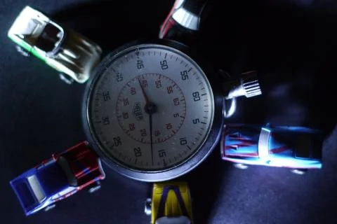 Stopwatch between car miniatures at scale Stock Photos