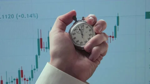 Stopwatch in a hand against background of chart 스톡 동영상 235156191