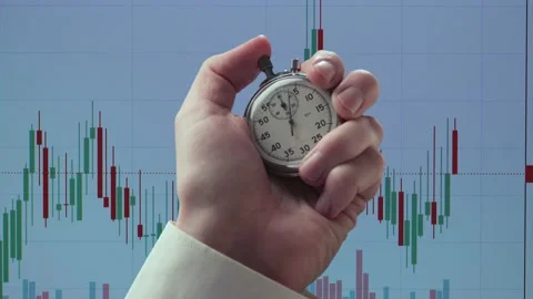 Stopwatch in a hand against background of chart Video stock 235156199