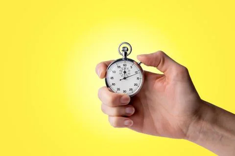 Stopwatch hold in hand, button pressed Stock Photos