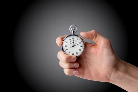 Stopwatch hold in hand, button pressed Stock Photos