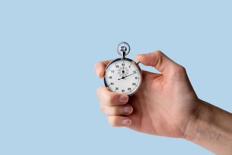 Stopwatch hold in hand, button pressed Stock Photos