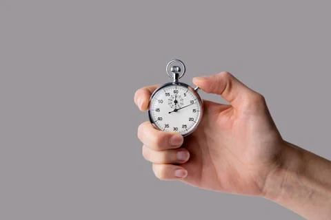 Stopwatch hold in hand, button pressed Stock Photos