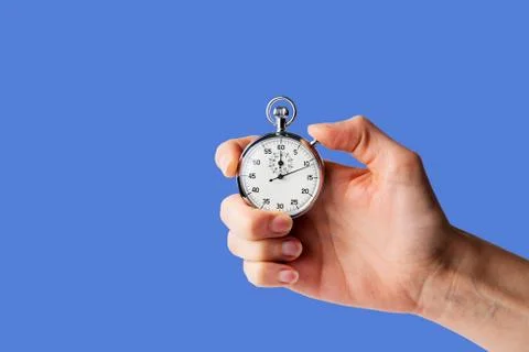 Stopwatch hold in hand, button pressed Stock Photos