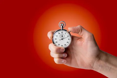 Stopwatch hold in hand, button pressed Stock Photos