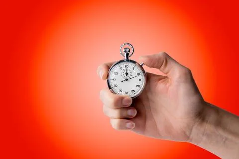 Stopwatch hold in hand, button pressed Stock Photos