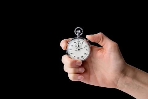 Stopwatch hold in hand, button pressed, black back ground Stock Photos