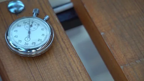 Stopwatch lies on bench, time shift concept Stock Footage 93651488