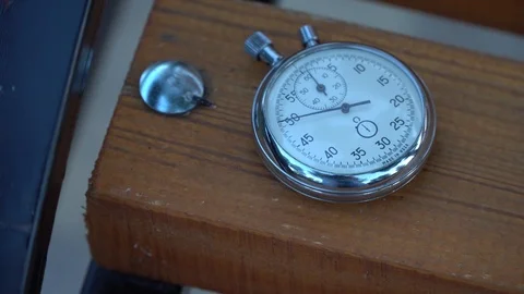Stopwatch lies on bench, time shift concept Stock Footage 93651753