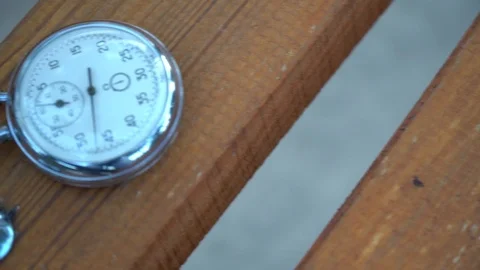 Stopwatch lies on bench, time shift concept Stock Footage 93652041