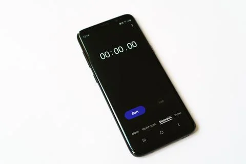 Stopwatch on smartphone screen on white background Stock Photos