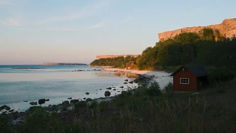 Stora Karlsö Cliffs at Sunset with Lilla Karlsö on Horizon Sweden Stock Footage 331554398