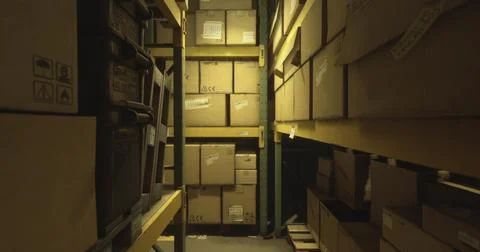 Storage area filled with stacked boxes in a dimly lit warehouse environment イラスト素材