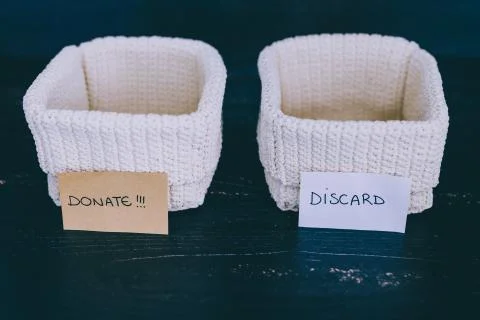 Storage baskets to divide items to keep from those to declutter or donate Stock Photos
