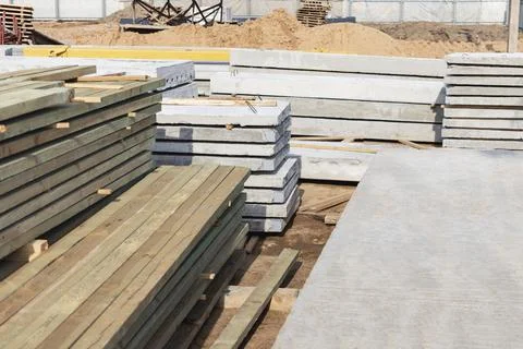 Storage of boards and building materials at the construction site. Stock Photos