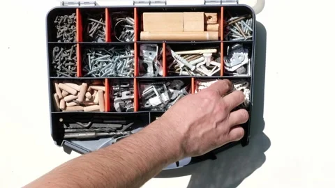 Storage box with small construction objects. Hand selects object Stock-Footage 199917135