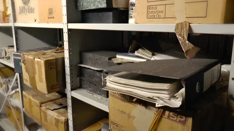 Storage boxes and old files on a metal shelf unit Video stock 57962344