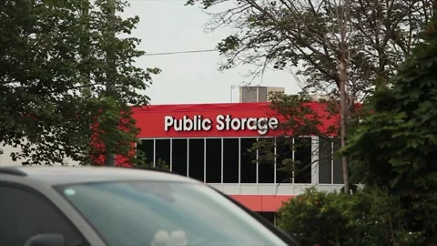 Storage building public storage in white writing on orange background Stock Footage 246611443