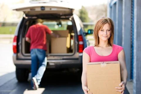 Storage: carrying a box to the storage unit Stock Photos