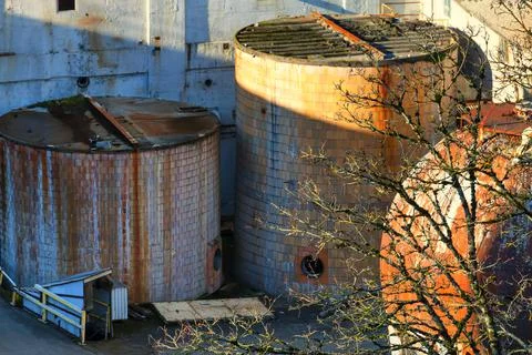 Storage containers at a closed down paper mill Stock Photos