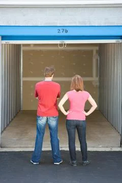 Storage: couple looking at empty unit Stock Photos