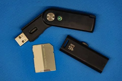 Storage device, such as SD card, USB flash drive, , on blue background Stock Photos