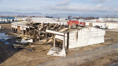 A storage facility destroyed by a large fire Stock Photos