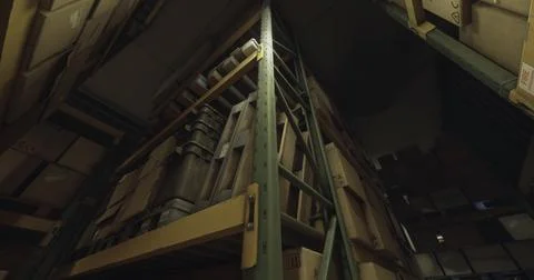 Storage facility filled with stacked boxes and shelving units at night Stockillustratie